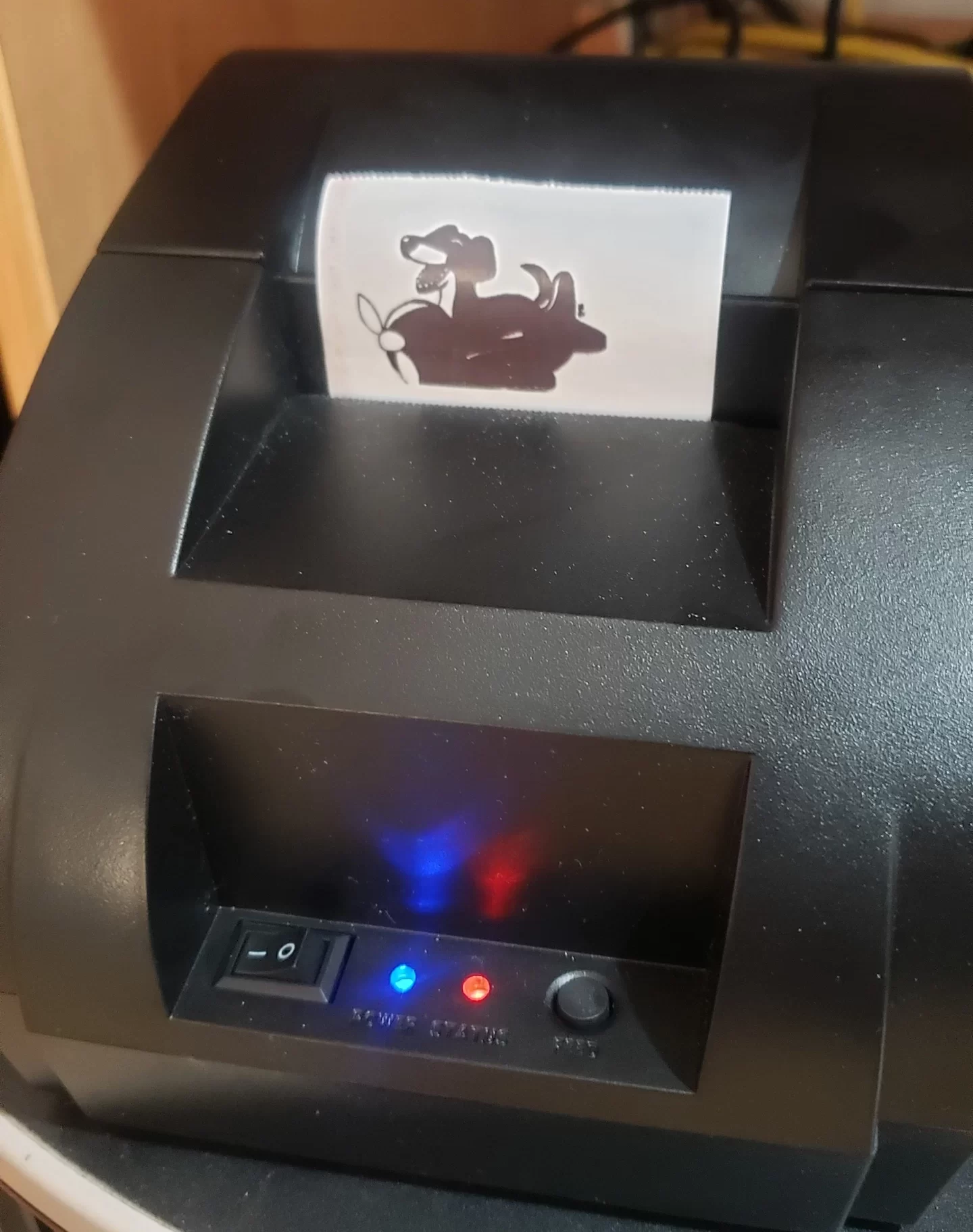 Printed receipt with Dog of Wisdom character from thermal printer